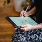 woman drawing sketch on graphic tablet
