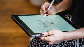 woman drawing sketch on graphic tablet